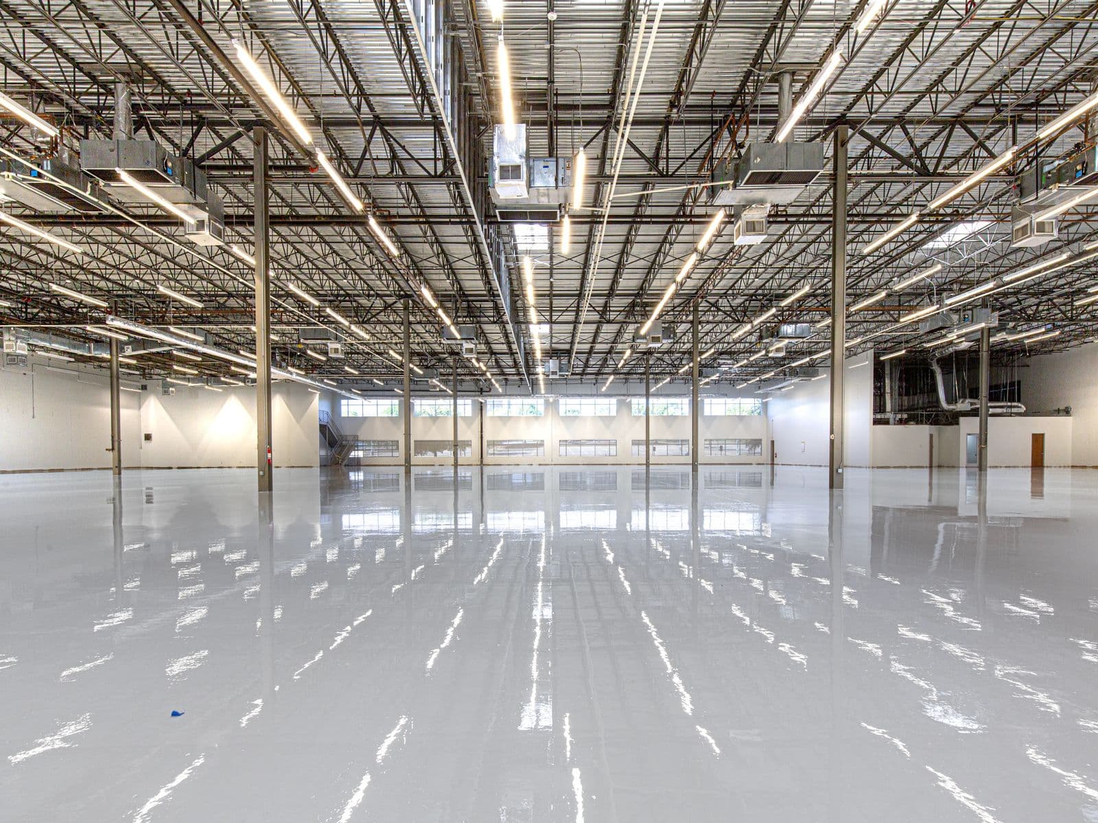 Spacious industrial warehouse with a polished, freshly cleaned epoxy floor