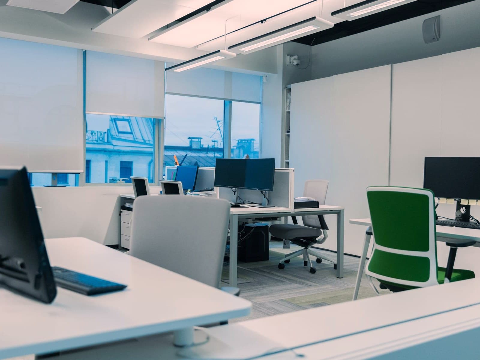 Modern open-plan office with partitioned workstations and clean grey carpet tile, the kind of space Bay Facility Management services across Northern Alabama